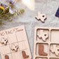 a wooden tic-tac-toe game with a Texas state shape on the board and wooden boot shapes on the game pieces.