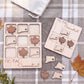 a wooden Tic-Tac Connecticut game board and several wooden leaf-shaped tiles, along with some autumn leaves on a plaid cloth.