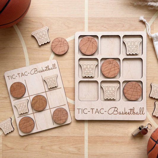 a wooden tic-tac basketball game with wooden basketballs and wooden basketball nets.