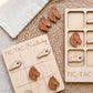 a wooden tic-tac game board with wooden horse head tiles and a wooden tic-tac card with wooden horse head tiles.
