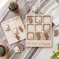 a wooden tic-tac game with Arizona state icons, including a cactus, placed on a table alongside other decorative items such as potted plants and a white cloth.