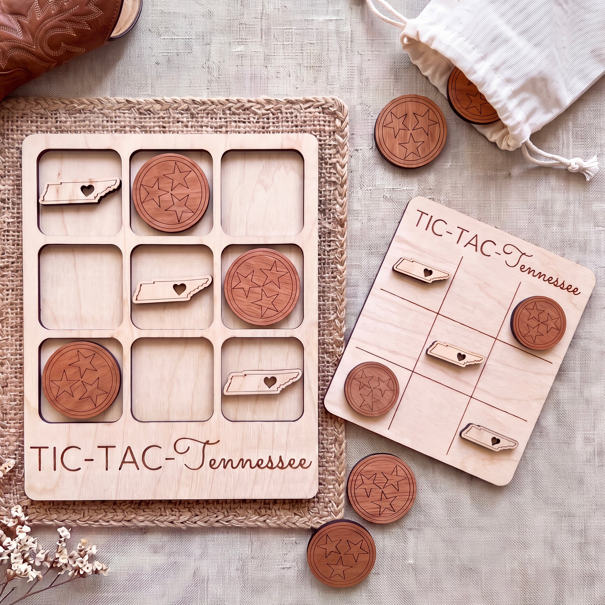 a wooden tic-tac game board and wooden tokens shaped like stars, with the word "TIC-TAC-Tennessee" written on them.