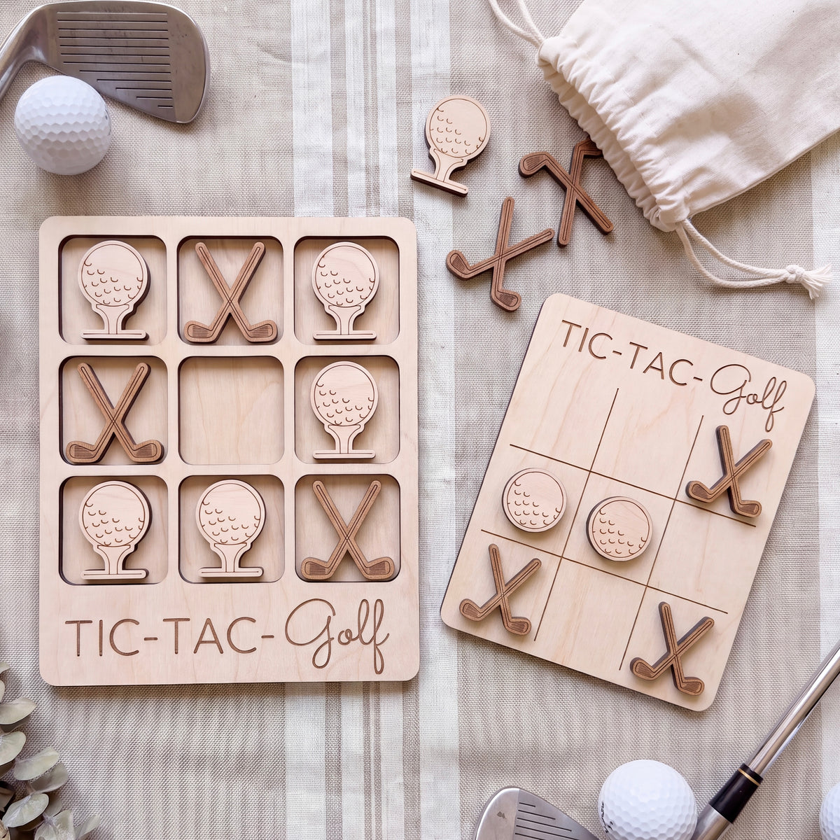 a wooden tic-tac golf game set with golf balls and clubs, along with a bag of golf clubs and a golf ball.
