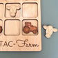 a wooden puzzle with farm animals and a tractor