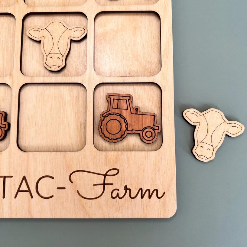 a wooden puzzle with farm animals and a tractor
