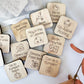 a bunch of wooden magnets with words on them