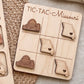 A wooden tic-tac game board with the state of Missouri marked on it, featuring wooden tic-tac pieces shaped like the state.