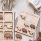 a wooden tic-tac game with a Texas state theme, including a wooden teddy bear and a wooden state flag. The game is placed on a white surface, and there is a white cloth and a small white bag in the background.