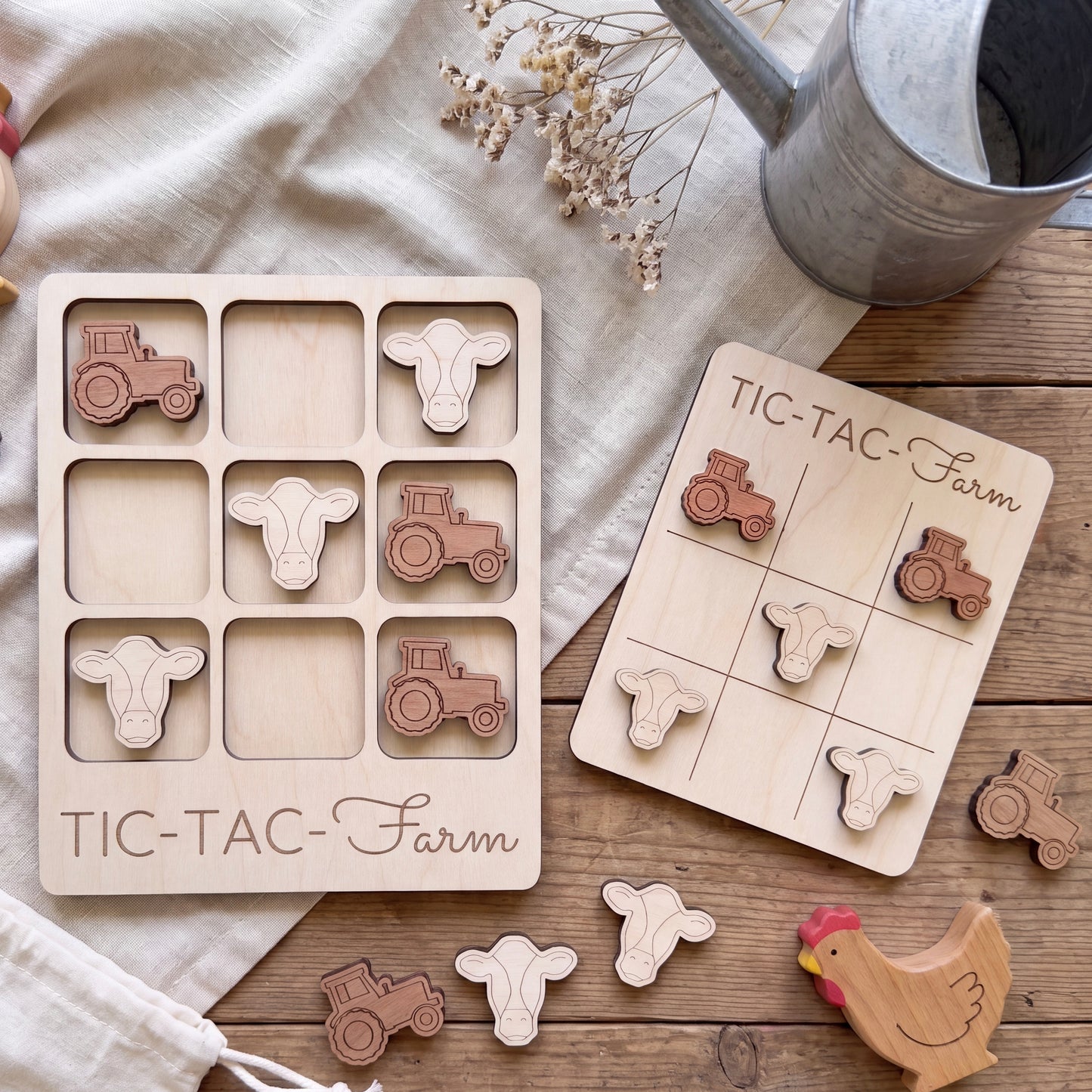 a wooden tic-tac farm game with tractor and tractor-related shapes, as well as a wooden chicken and tractor set, all placed on a wooden surface.