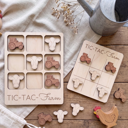 a wooden tic-tac farm game with tractor and tractor-related shapes, as well as a wooden chicken and tractor set, all placed on a wooden surface.