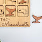 a wooden puzzle with a picture of massachusetts