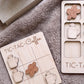 a wooden tic-tac game with coffee-themed tiles and wooden coffee cups, as well as a wooden tic-tac card with coffee-themed tiles and wooden coffee cups.