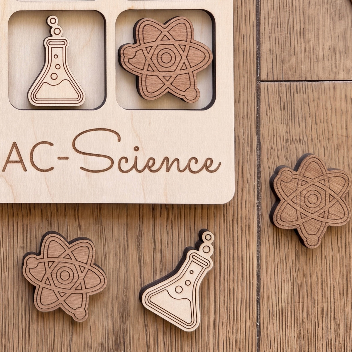 a wooden puzzle board with various science-themed pieces, including a molecule, a flask, and a star.