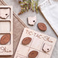 a wooden tic-tac game with the word "Ohio" written on it, along with several wooden pieces shaped like Ohio state symbols, such as a heart and a football.