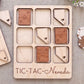A wooden Tic-Tac-themed game board with wooden tiles shaped like playing cards and the word "TIC-TAC-New Mexico" written on it.