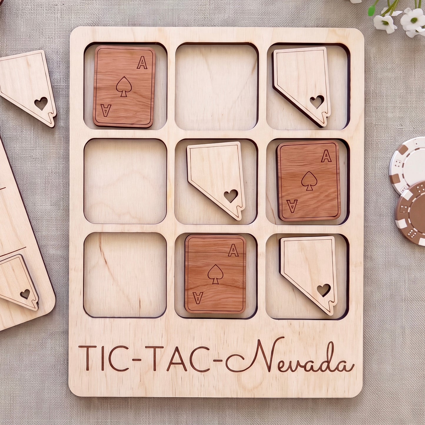 A wooden Tic-Tac-themed game board with wooden tiles shaped like playing cards and the word "TIC-TAC-New Mexico" written on it.