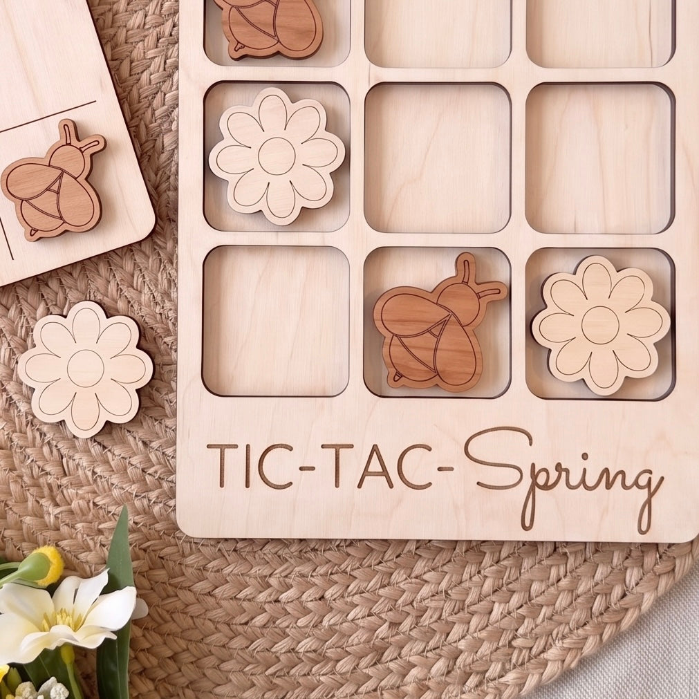 a wooden tic-tac game board with wooden pieces shaped like flowers and a wooden bee. The game board is labeled "TIC-TAC-Spring".
