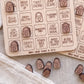 a collection of wooden game pieces with spooky faces, likely intended for a game or activity related to the theme of the spooky house.