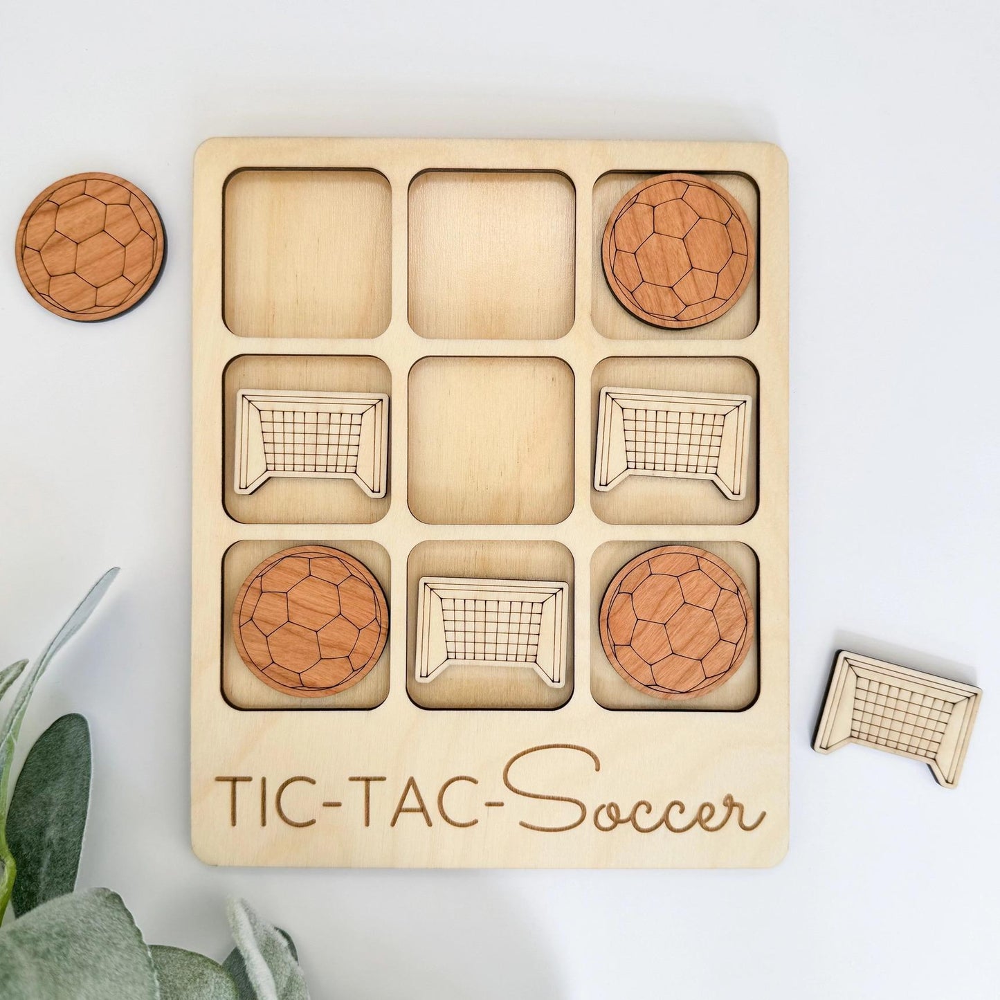 a wooden tic - tac - soccer game with four balls