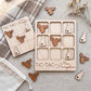 a wooden tic-tac game with a New Hampshire theme, including a wooden tic-tac board and wooden tic-tac pieces shaped like moose heads.