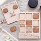 a wooden Tic-Tac-To-Hockey game board and several wooden pieces shaped like hockey sticks and pucks.