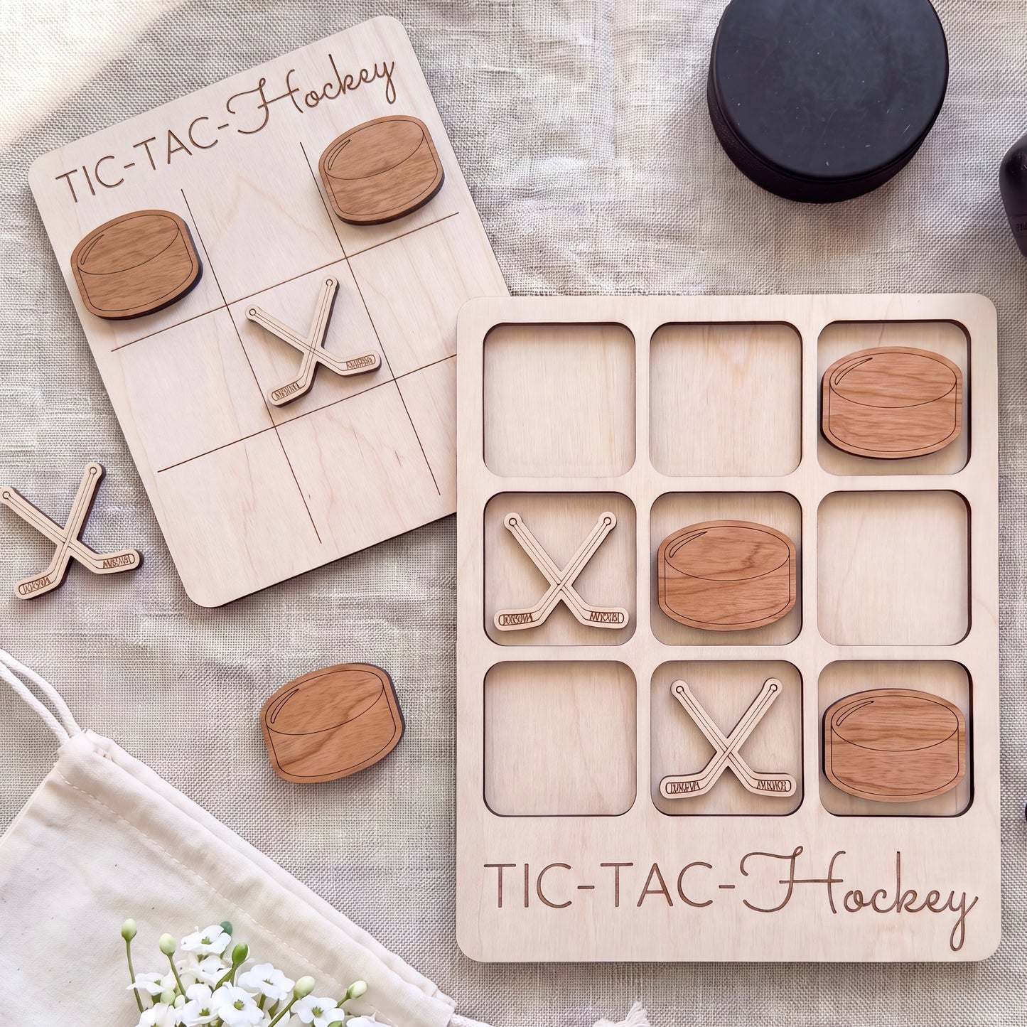 a wooden Tic-Tac-To-Hockey game board and several wooden pieces shaped like hockey sticks and pucks.