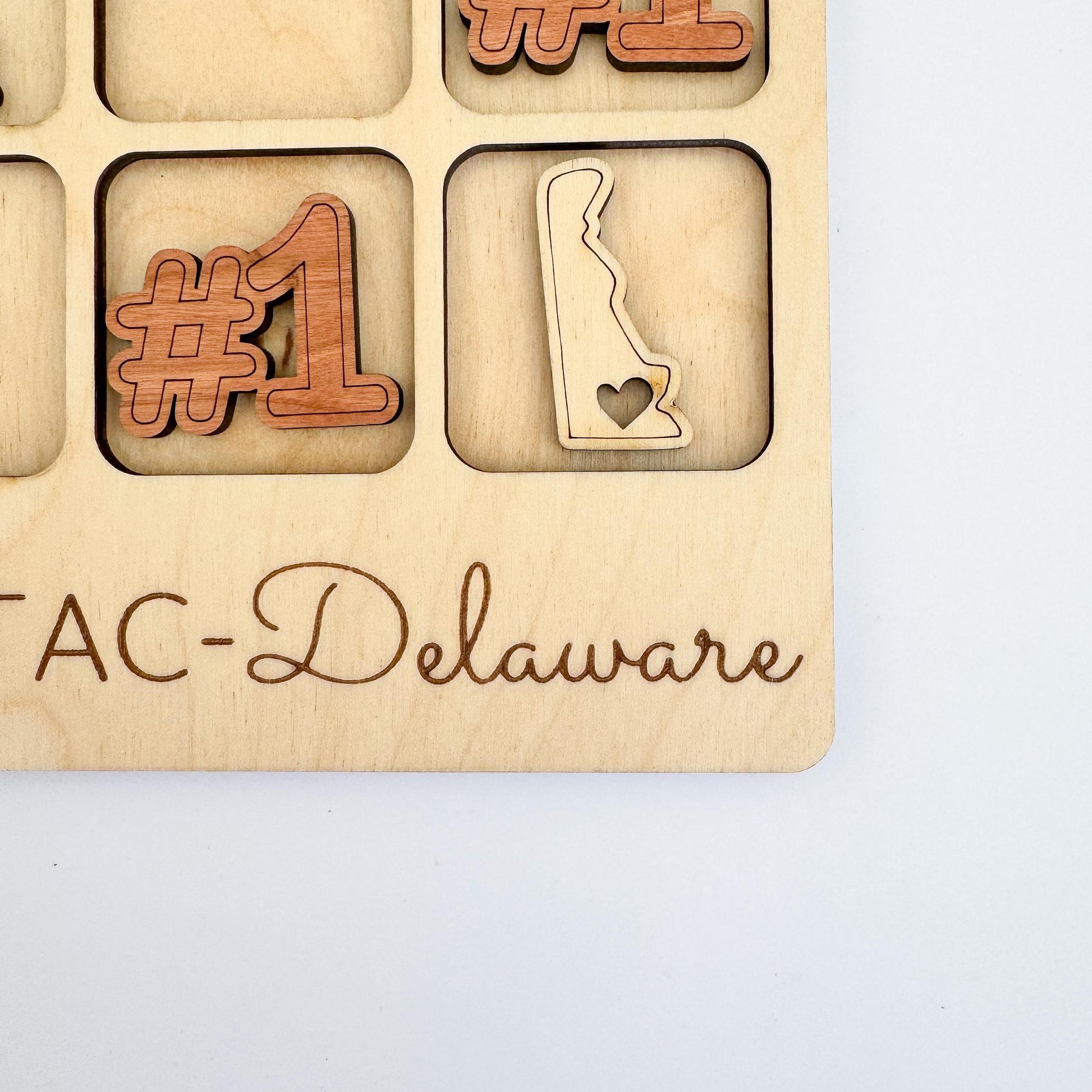 a wooden plaque with the words tac - delaware on it