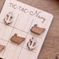 A wooden tic-tac game board with wooden tic-tac pieces shaped like anchors, labeled "TIC-TAC-Navy".