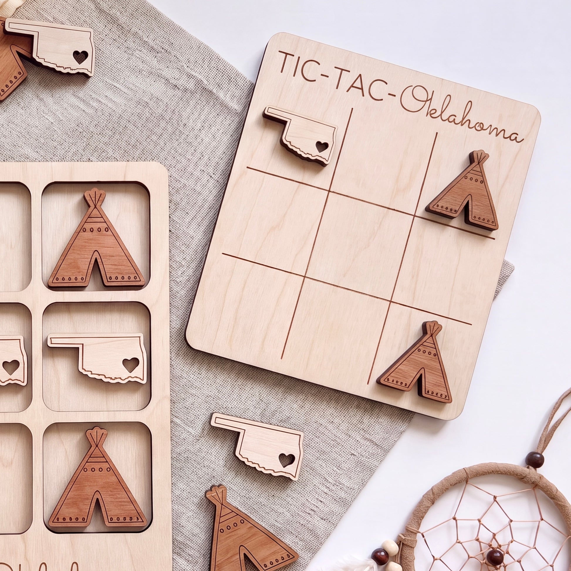 a wooden tic-tac game board with wooden tiki-style pieces and a dreamcatcher.