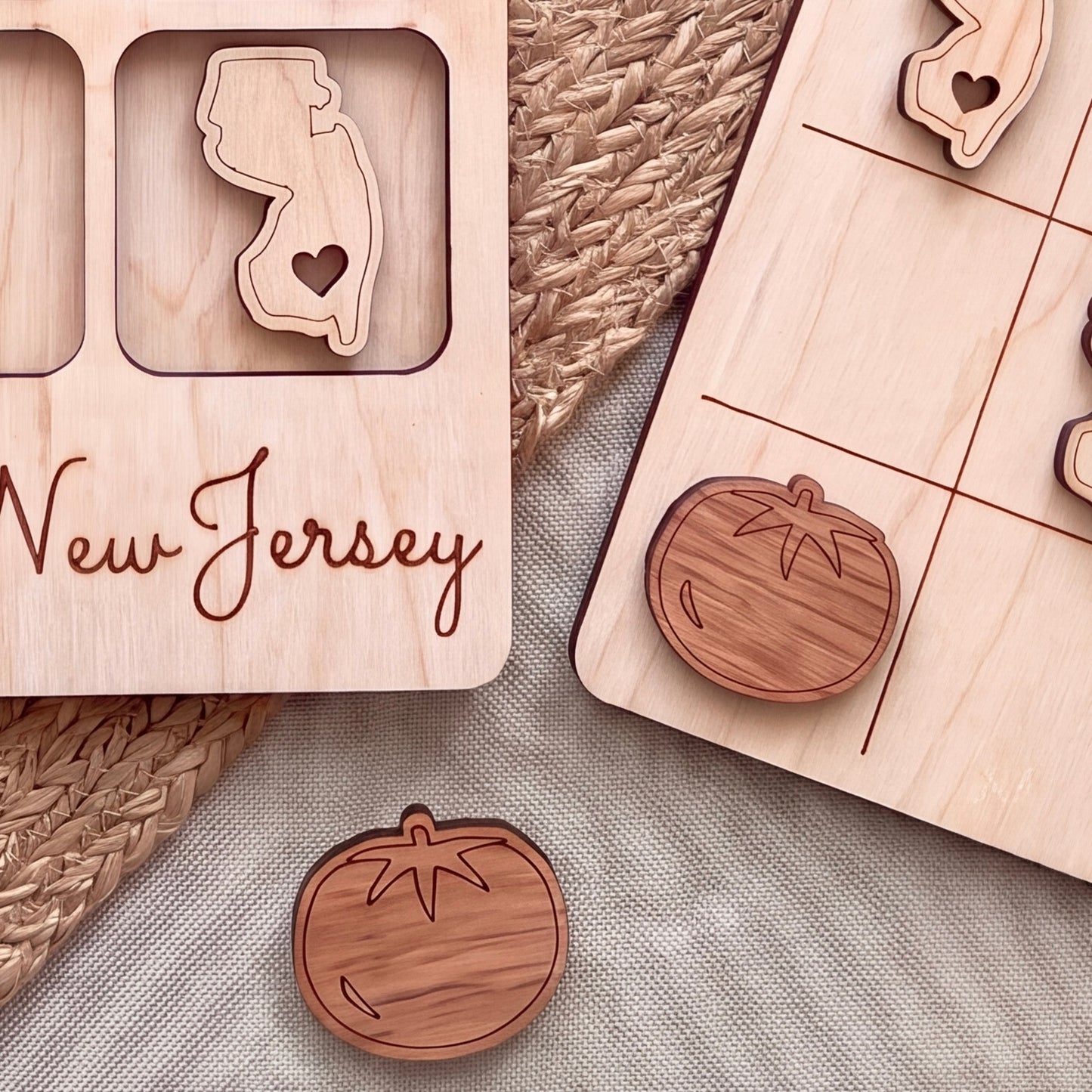 a wooden frame with a New Jersey state map and a wooden tic-tac game board with wooden tiles.