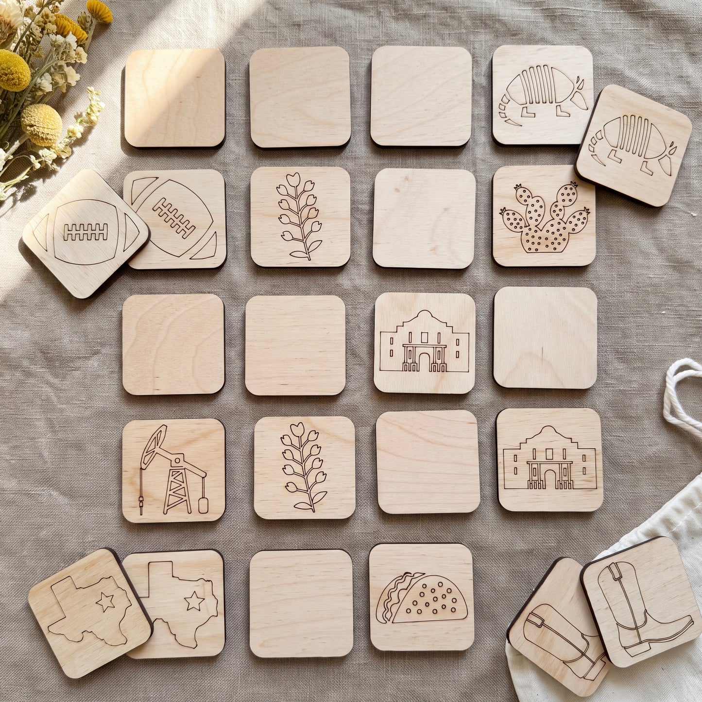 a collection of wooden coasters featuring various illustrations, including a football, a plant, a building, a cactus, and other symbols.