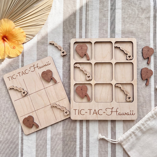 a wooden tic-tac game set with heart-shaped pieces and a wooden board labeled "TIC-TAC-Hawaii".