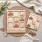 a wooden tic-tac game set with wooden pieces shaped like states, including one shaped like Missouri. The game is placed on a woven placemat, and there are some additional wooden pieces scattered around the game.