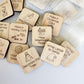 a bunch of wooden magnets with words on them