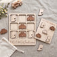 a wooden tic-tac game set with wooden pieces shaped like Indiana state symbols, along with a wooden toy car and a white cloth.