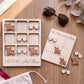 a wooden game board labeled "TIC-TAC-Air Force" and a pair of sunglasses, along with some additional sunglasses and a pair of sunglasses on a wooden surface.