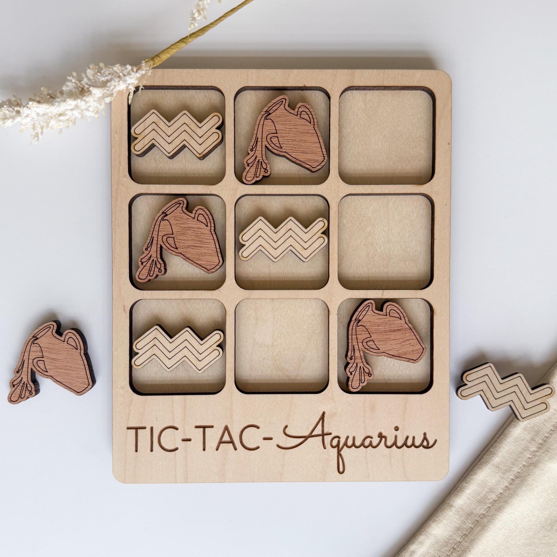 A wooden tic-tac game board with wooden tiles shaped like zigzags and a wooden token shaped like a zigzag.