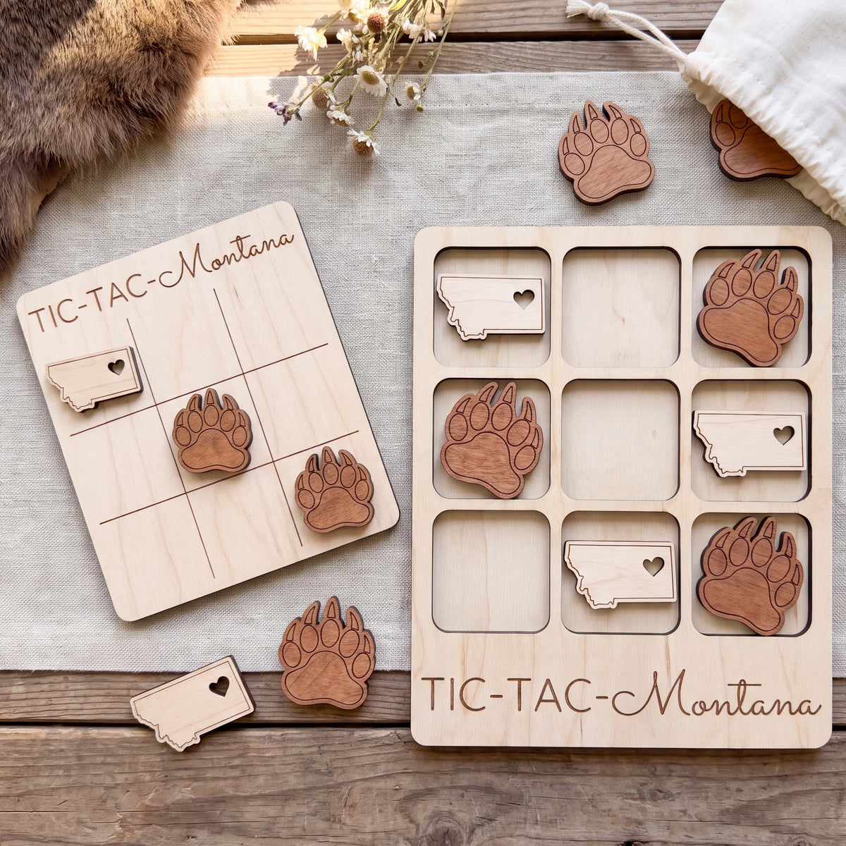 a wooden tic-tac game with a Minnesota state theme, including wooden paw prints and a Minnesota state shape.