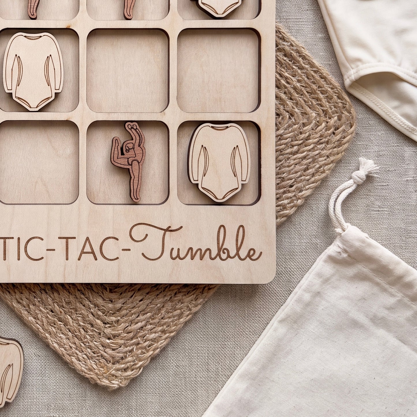a wooden tic-tac-tacle game with a wooden board and a white cloth bag.