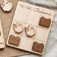 A wooden tic-tac board game with book-themed tiles, featuring a book worm and an open book.