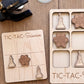 a wooden tic-tac game board with a science theme, along with several wooden tic-tac tokens shaped like laboratory equipment.