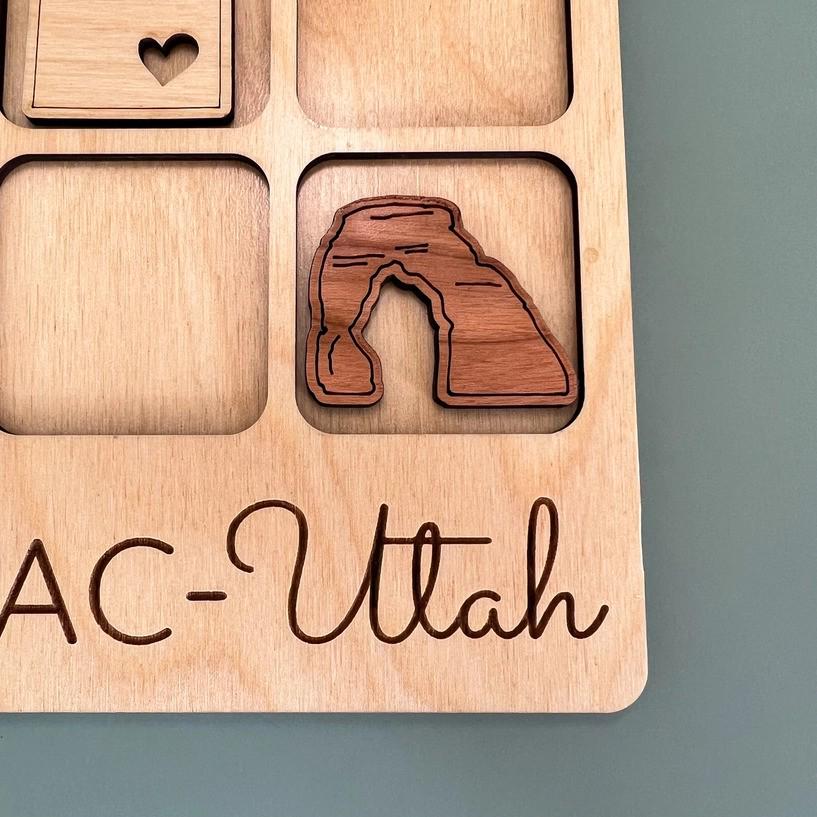 a wooden magnet with a picture of a rock formation