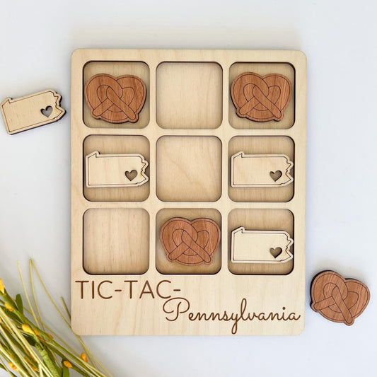 a wooden tic - tac pennsylvania puzzle with hearts